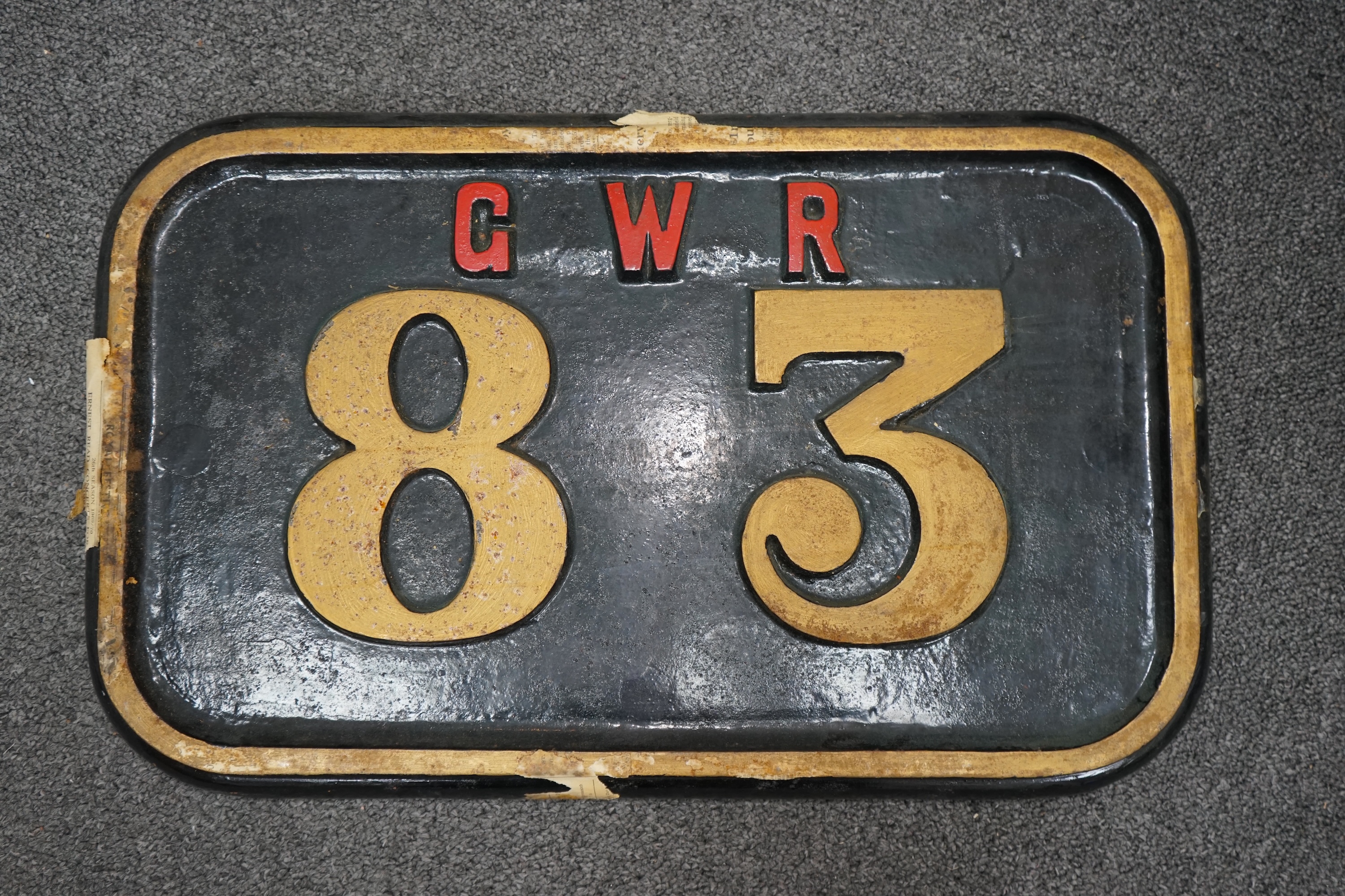 A cast iron GWR locomotive cab side number plate for a P Class 0-6-2T locomotive, 83, built in 1909 by Robert Stephenson and Company for the Rhymney Railway, dimensions; 47.5cm x 29.5cm. Condition - fair to good, general